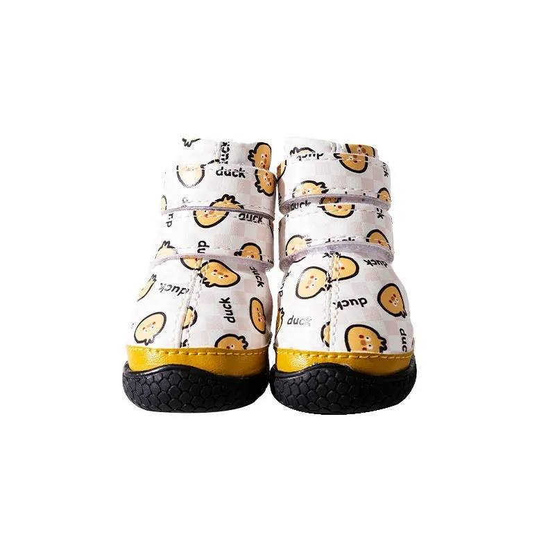 Fleece-lined waterproof dog boots in yellow with non-slip rubber sole on a wooden floor