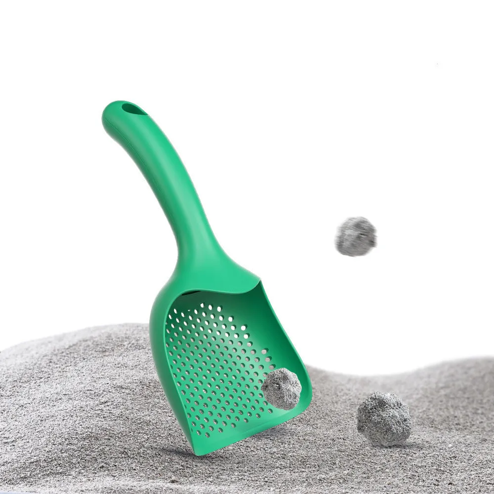 Green plastic cat litter scoop with hollow head and handle on white background