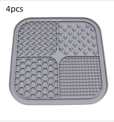 Green silicone pet licking pad 20x20cm with suction cup base on a tiled floor