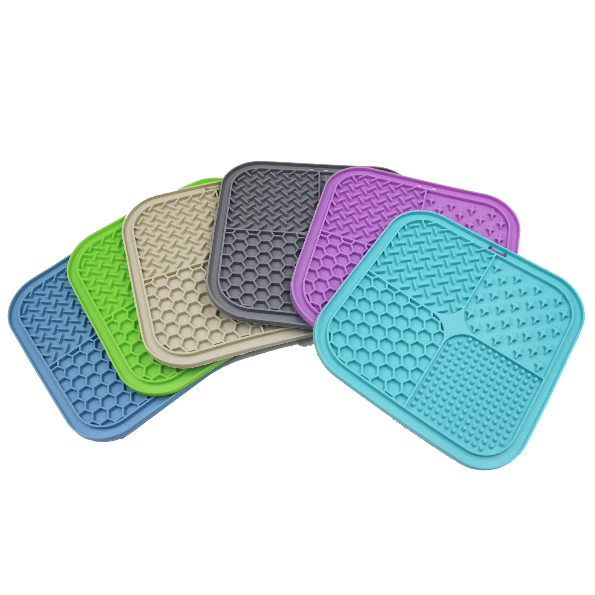 Green silicone pet licking pad 20x20cm with suction cup base on a tiled floor