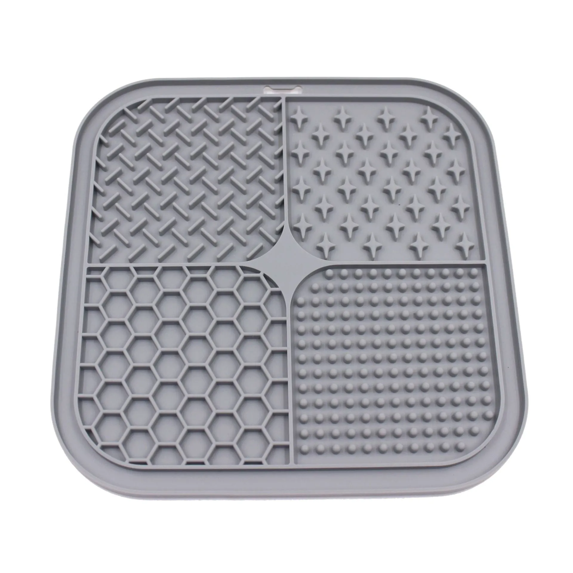 Green silicone pet licking pad 20x20cm with suction cup base on a tiled floor