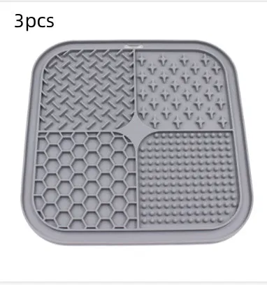 Green silicone pet licking pad 20x20cm with suction cup base on a tiled floor