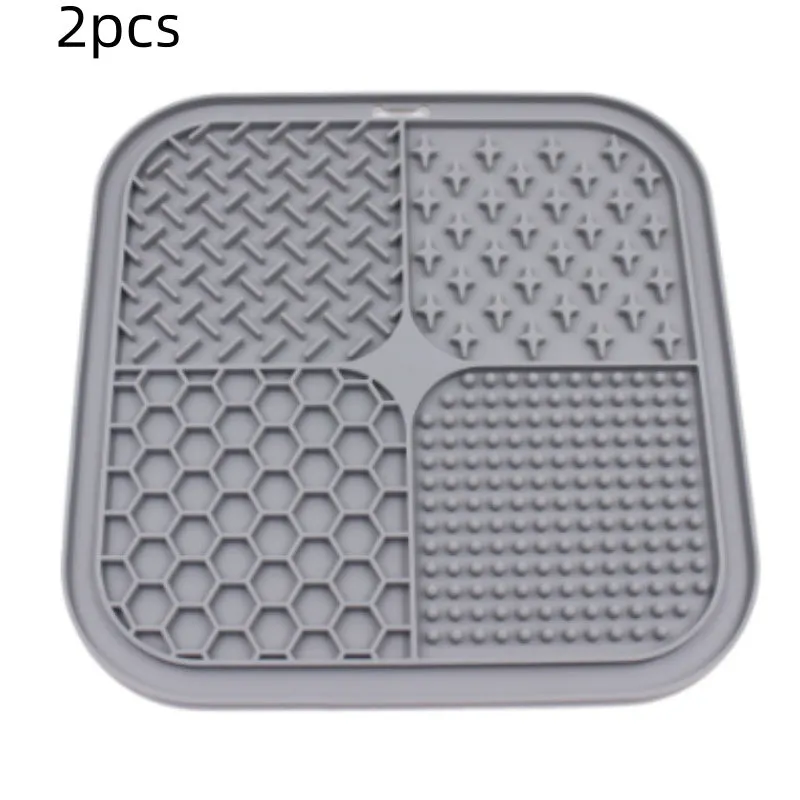 Green silicone pet licking pad 20x20cm with suction cup base on a tiled floor