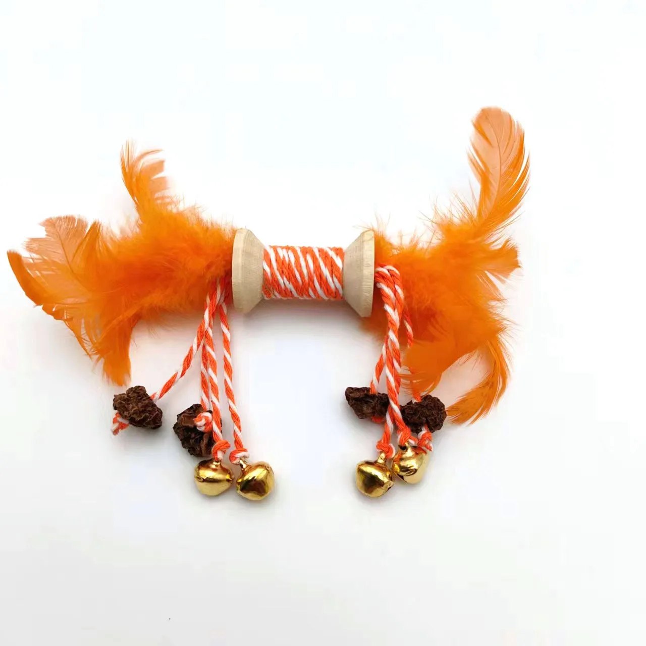 Feather bell gall fruit cat toy in ginger colour with bells and feathers on green background