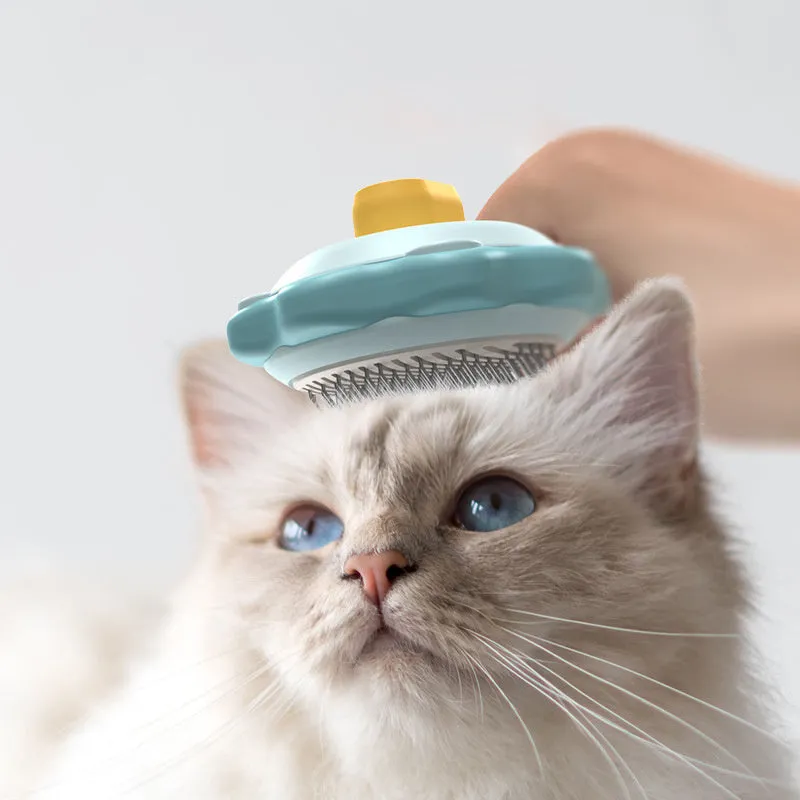 Stainless steel pet comb with one-click hair removal in blue, pink, and yellow colours on white background