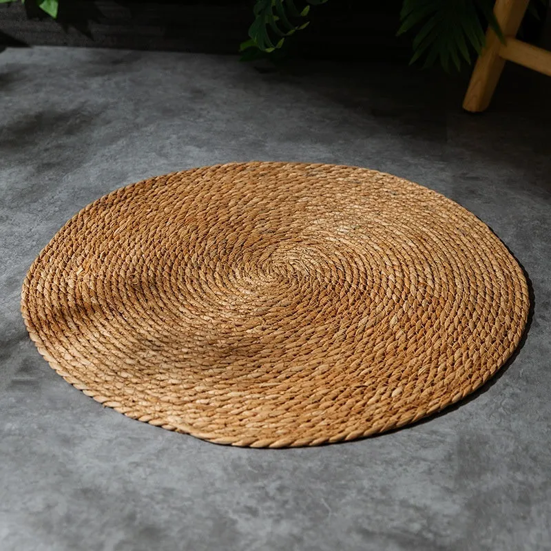 Natural papyrus round rattan cat scratching pad in winter brown colour on floor