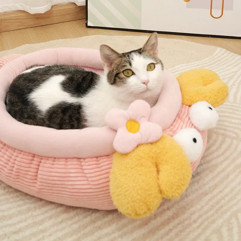 Pink semi-enclosed lobster pet nest with teddy fleece interior and non-slip base on a wood floor