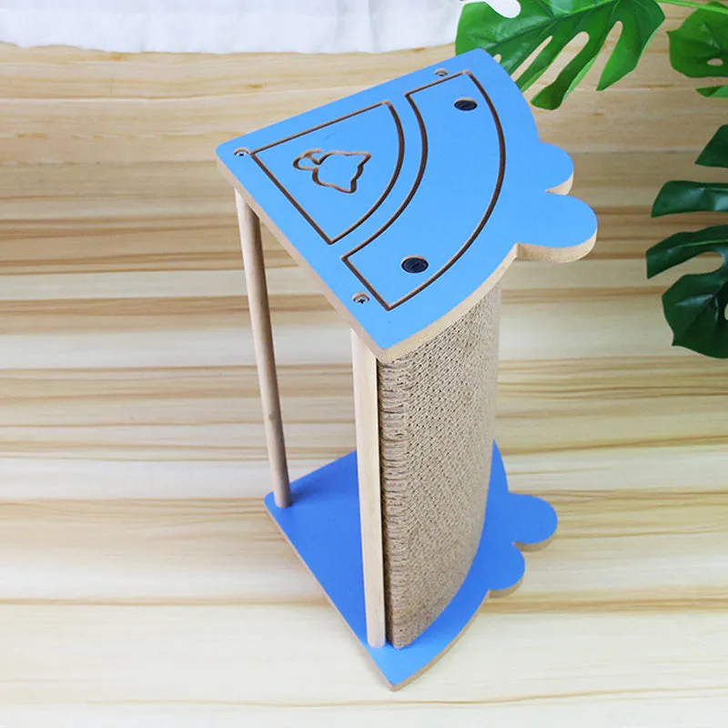 Triangular cardboard cat scratching pad positioned in room corner with hanging ball