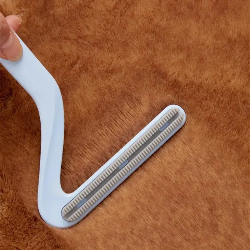 Double-sided pet hair removal comb in blue for removing cat and dog fur from beds and upholstery