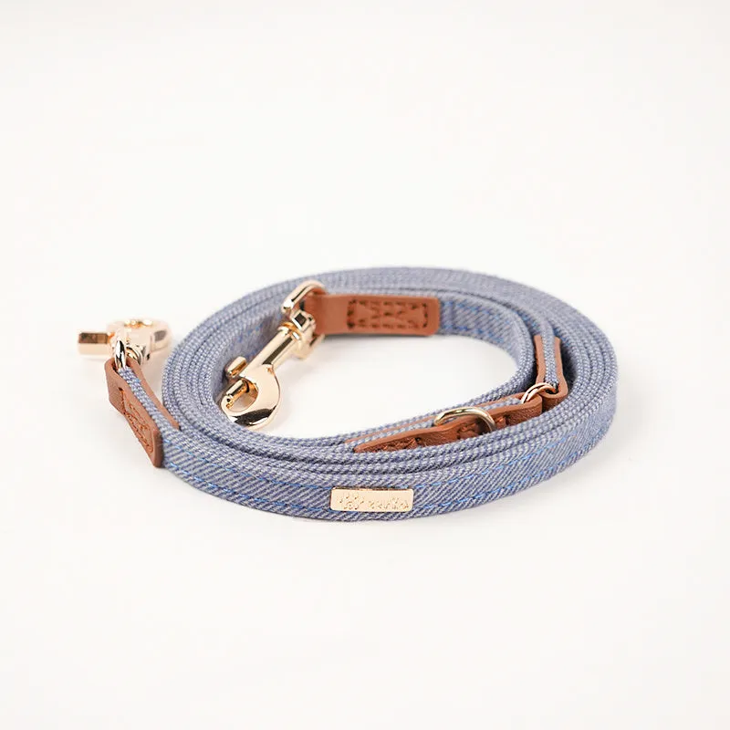 Adjustable mohair dog collar with nameplate and hand holding rope in cement gray