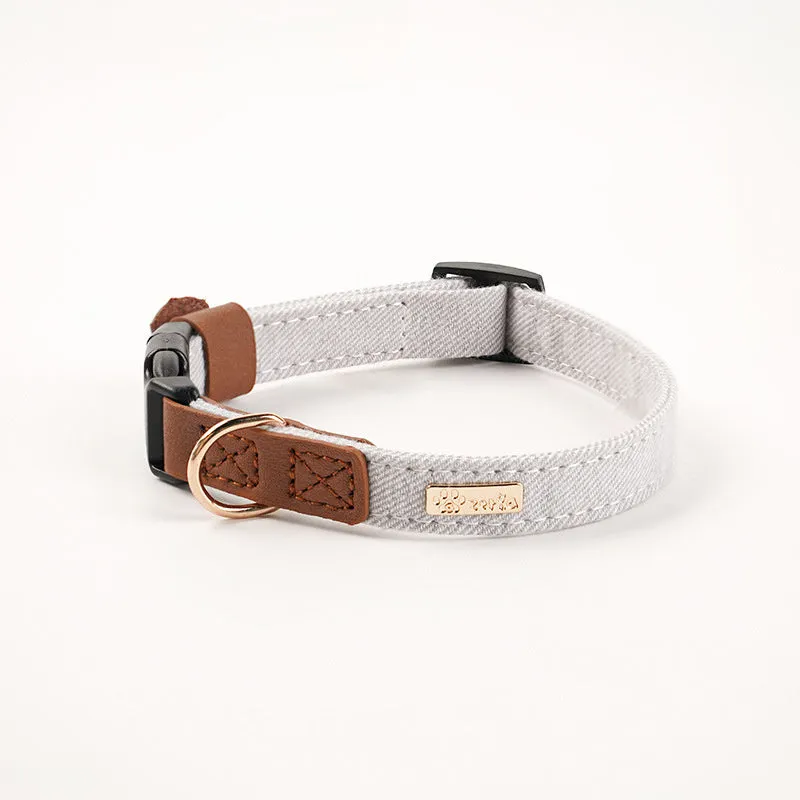 Adjustable mohair dog collar with nameplate and hand holding rope in cement gray