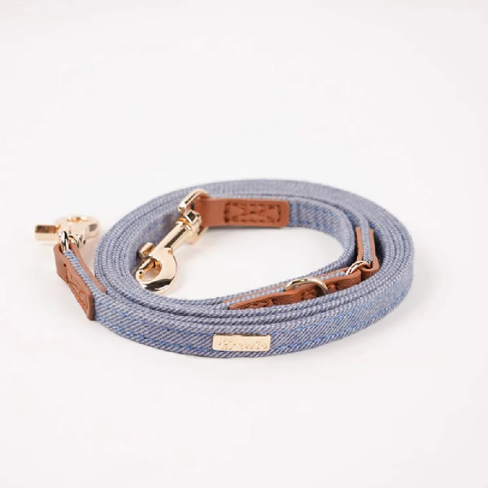 Adjustable mohair dog collar with nameplate and hand holding rope in cement gray