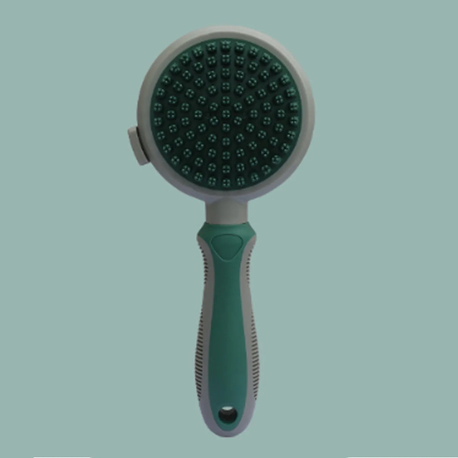 Green and pink double-sided cat brush with release button and included flea comb for pet grooming