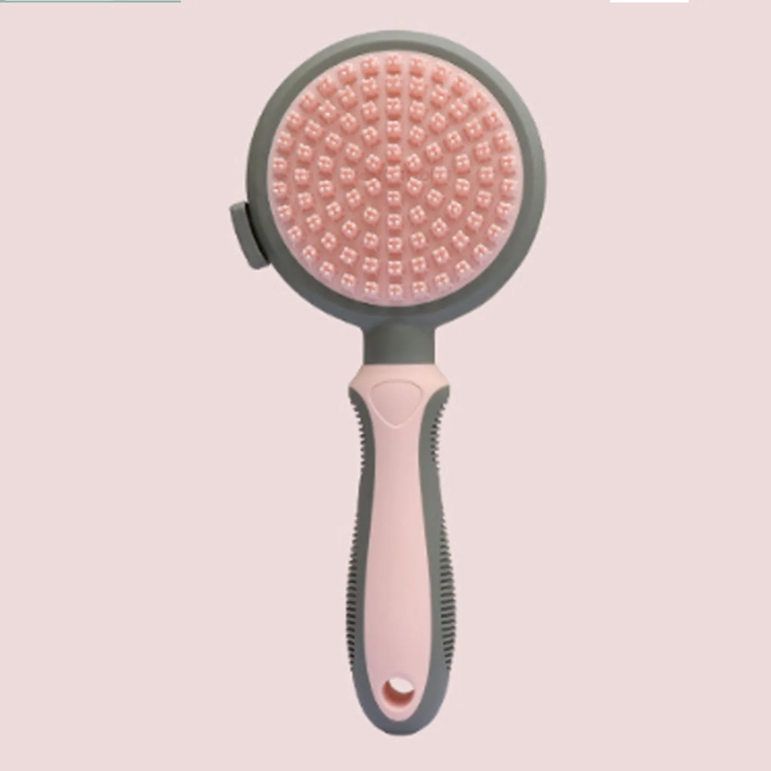 Green and pink double-sided cat brush with release button and included flea comb for pet grooming