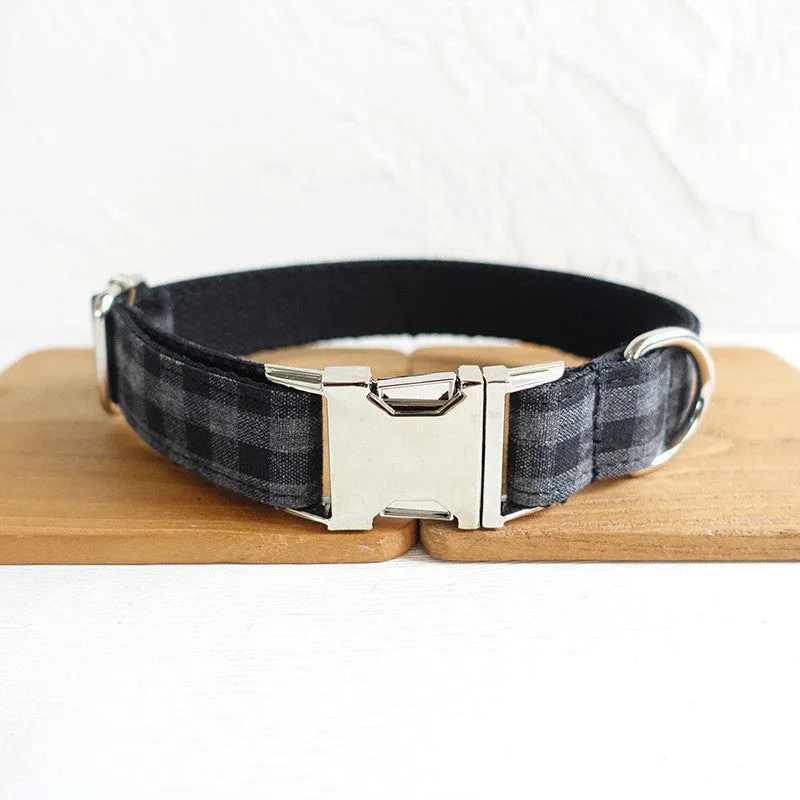 Black polyester dog training leash with metal chain ring on a plain background