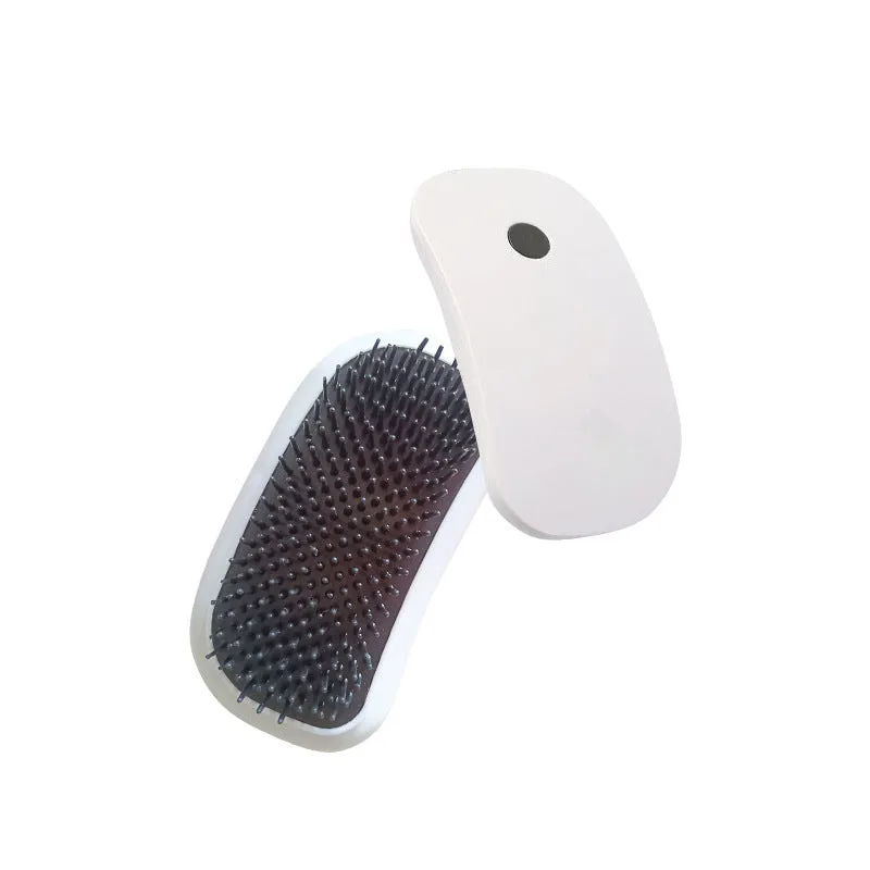 Pink handheld electric pet grooming brush with soft TPE teeth for cats and dogs.