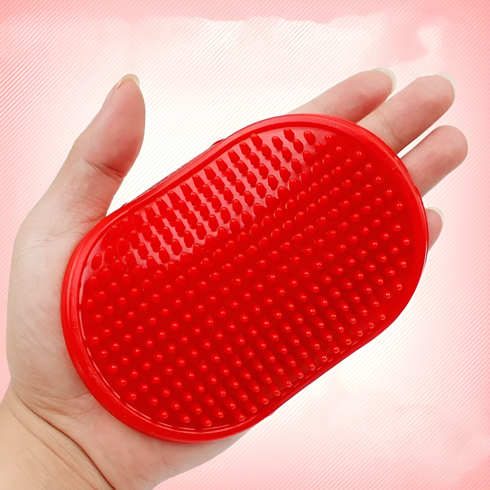 Oval rubber pet bath brush in hand for dog or cat grooming, red colour