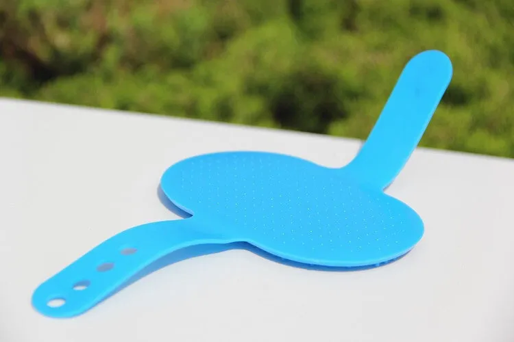 Oval rubber pet bath brush in hand for dog or cat grooming, red colour