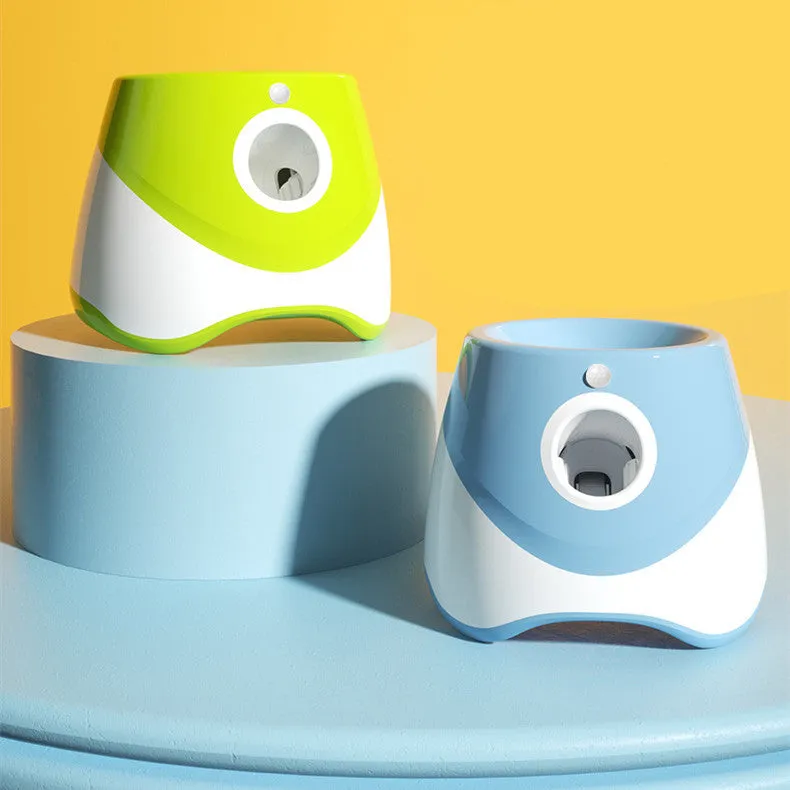 Blue automatic ball thrower with thermal sensor, three tennis balls, and USB charging cable on grass