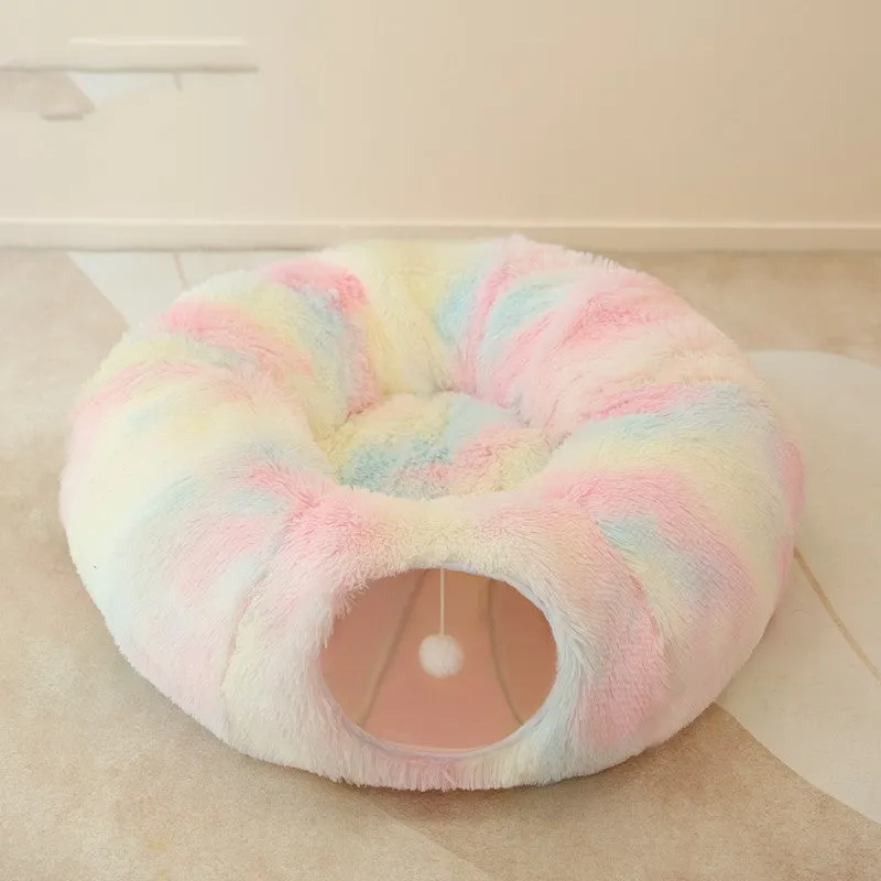 Closed cat tunnel nest 95cm made of long fluffy plush in rainbow colour on a wooden floor