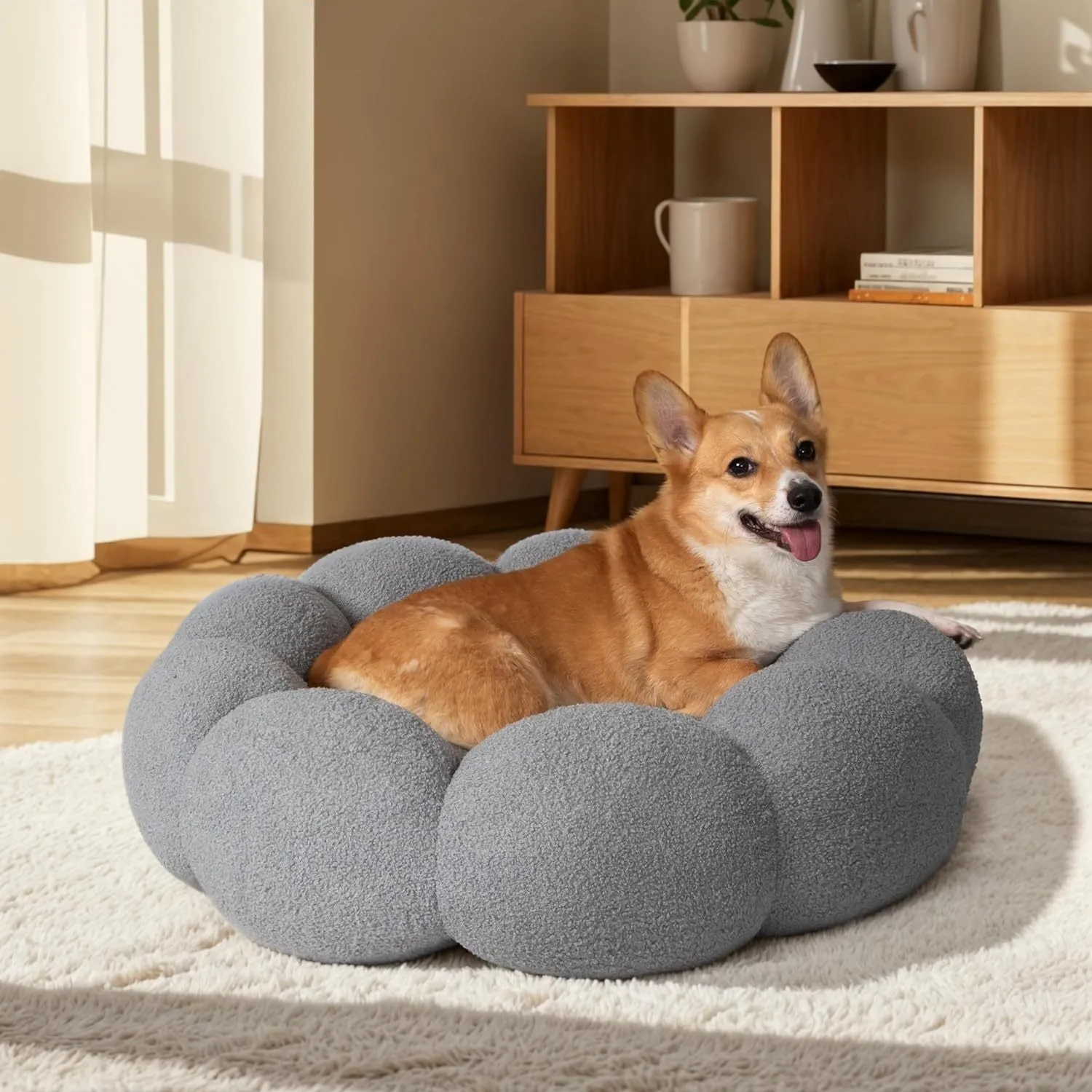 White fluffy flower-shaped pet bed with raised teddy fleece edges and round donut design on a light floor