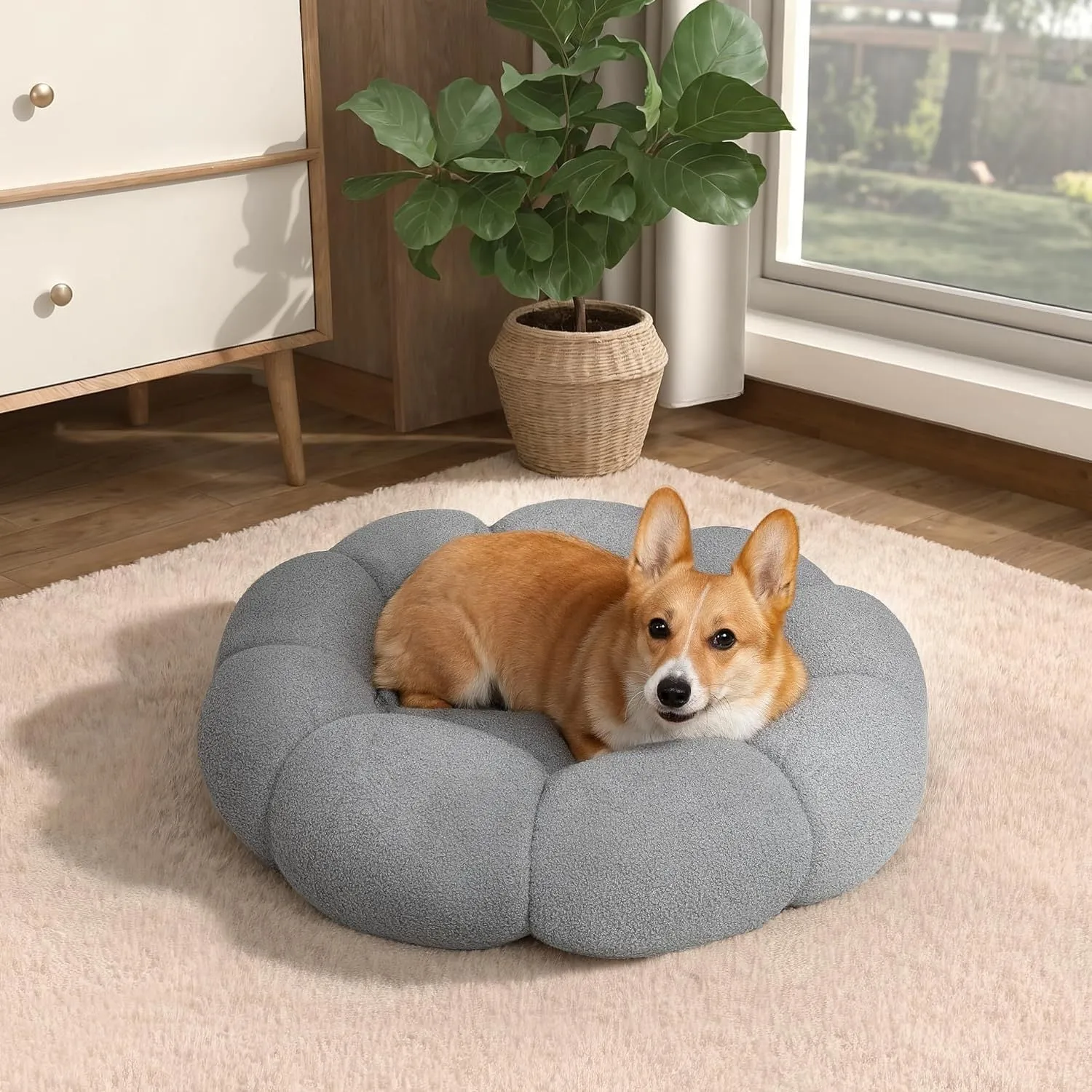 White fluffy flower-shaped pet bed with raised teddy fleece edges and round donut design on a light floor