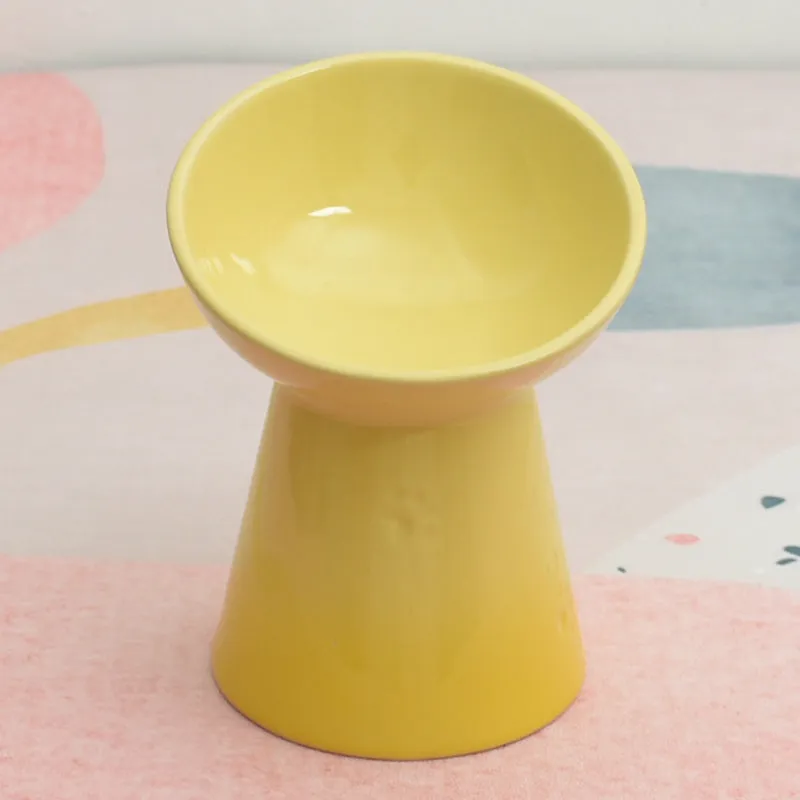 Ceramic pet bowl with a high foot and wide rim for dogs and cats.