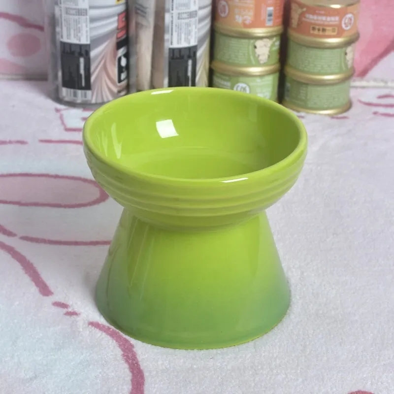 Ceramic pet bowl with a high foot and wide rim for dogs and cats.