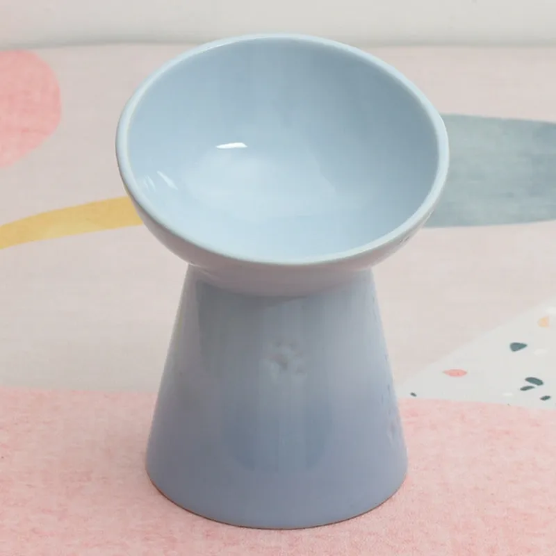 Ceramic pet bowl with a high foot and wide rim for dogs and cats.