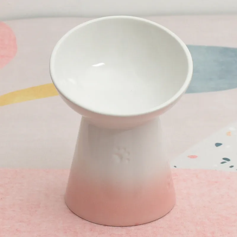 Ceramic pet bowl with a high foot and wide rim for dogs and cats.