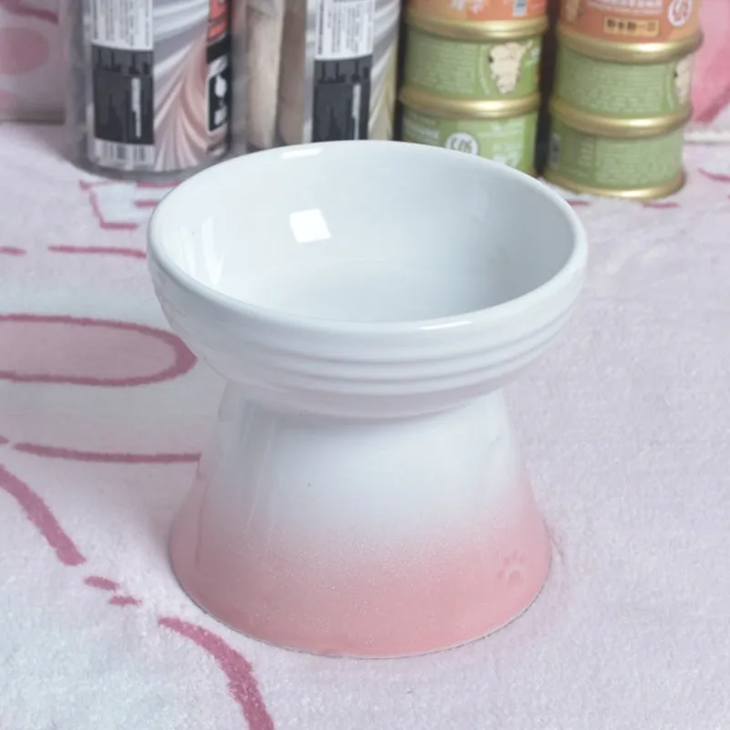 Ceramic pet bowl with a high foot and wide rim for dogs and cats.