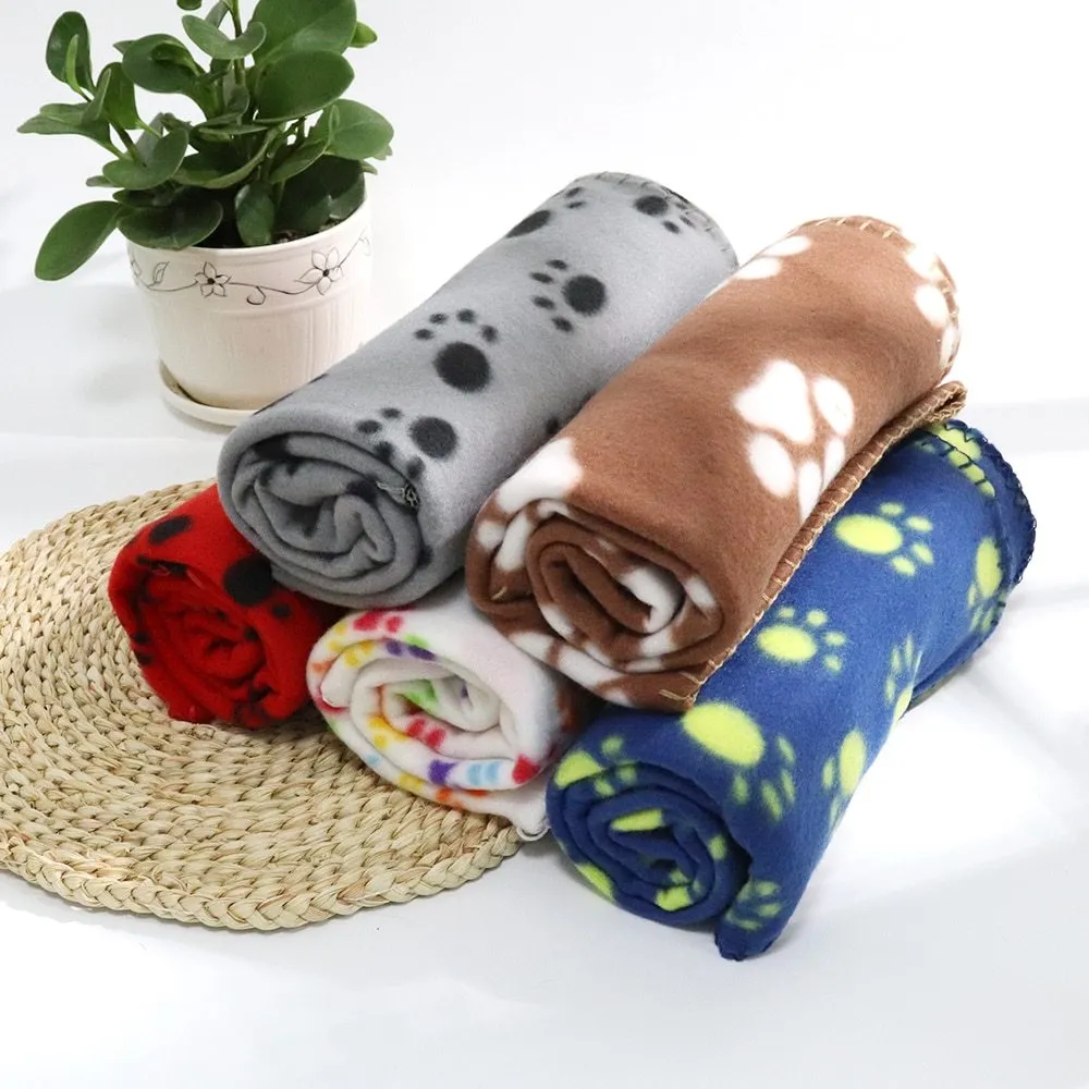 Pet warm blanket with paw print design double-sided fleece in blue colour, laid flat on a surface