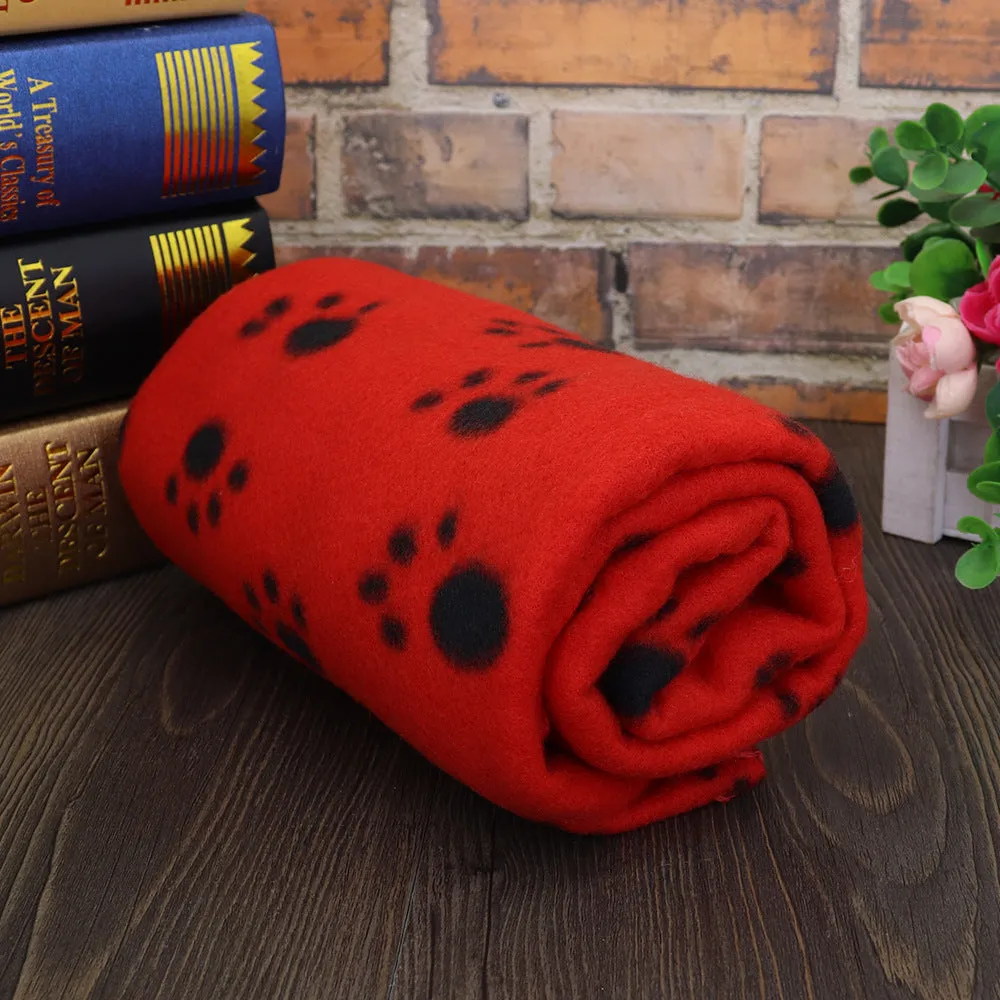 Pet warm blanket with paw print design double-sided fleece in blue colour, laid flat on a surface
