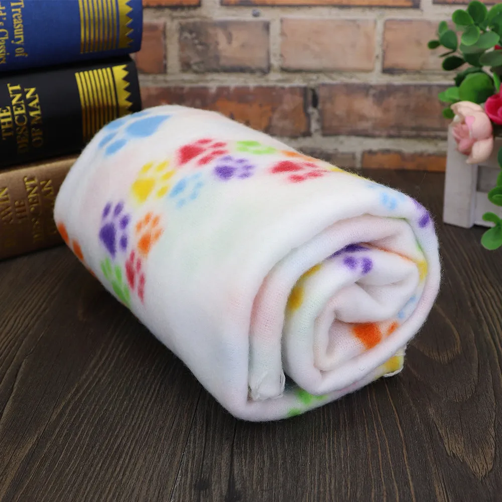 Pet warm blanket with paw print design double-sided fleece in blue colour, laid flat on a surface