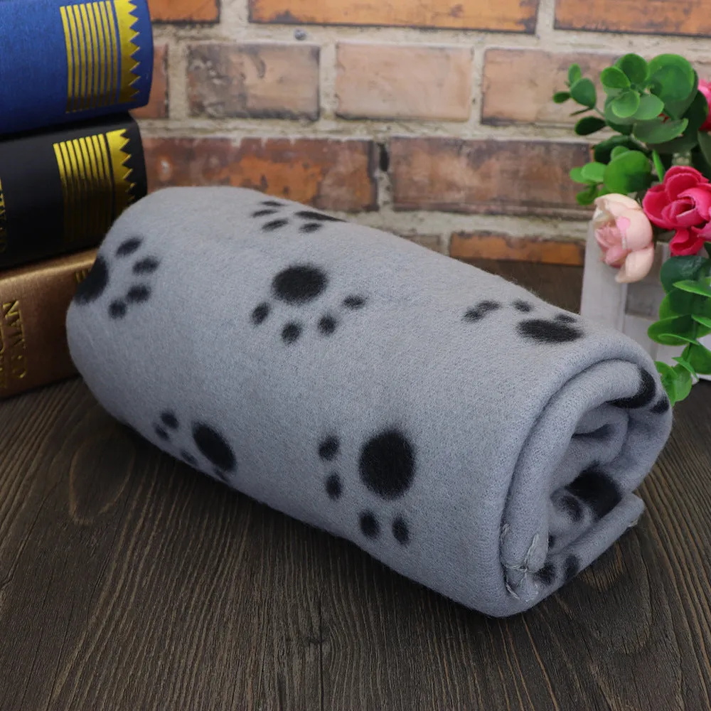 Pet warm blanket with paw print design double-sided fleece in blue colour, laid flat on a surface