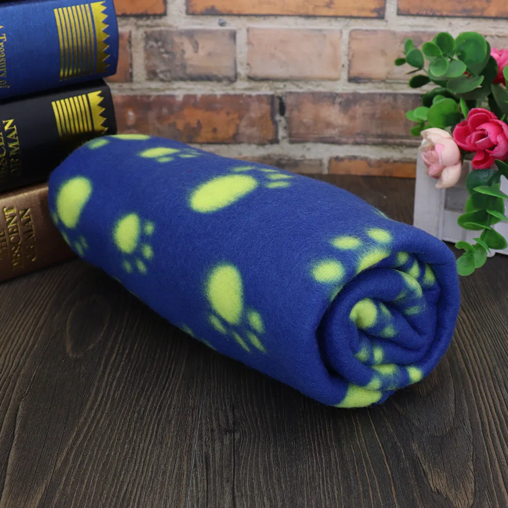Pet warm blanket with paw print design double-sided fleece in blue colour, laid flat on a surface