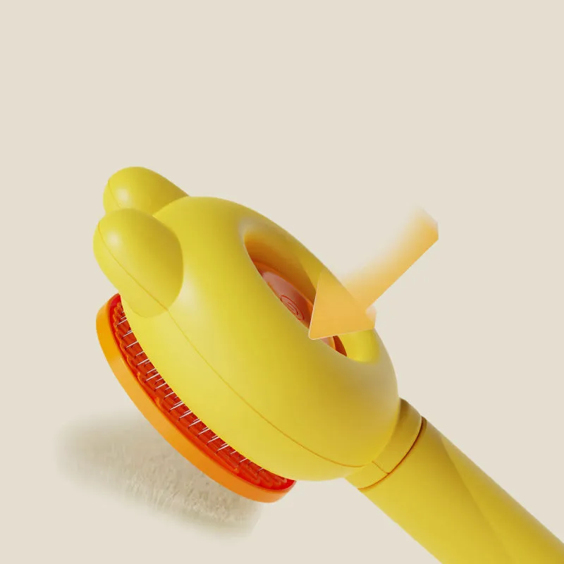 Self-cleaning pet brush with coloured comfort-grip handle and metal comb, shown with release button activated.