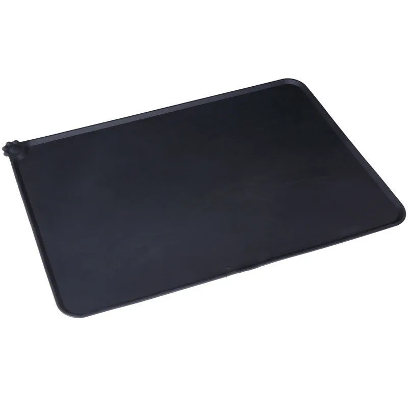 Black silicone dog food mat measuring 47 by 30 centimetres with non-slip surface and raised edges.