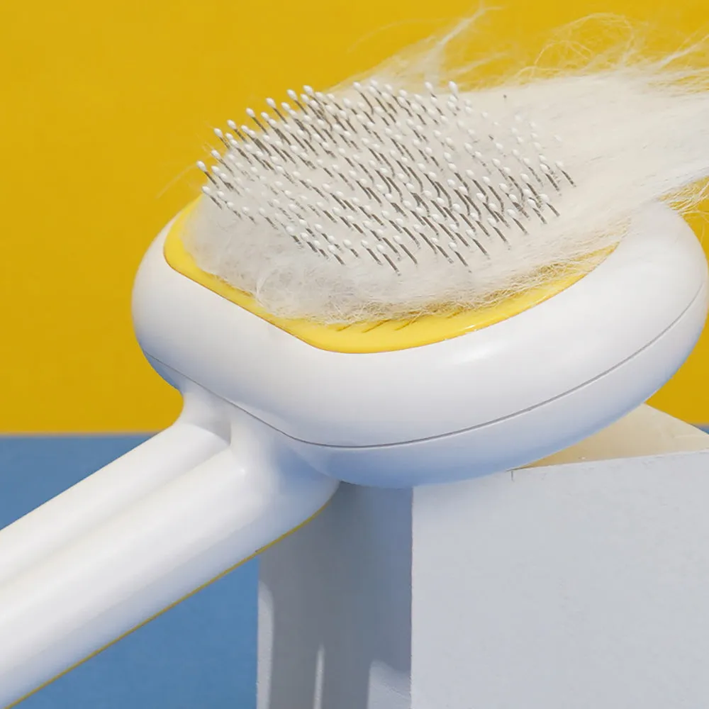 Cat dog grooming brush with stainless steel teeth and white silicone tips on a gray handle