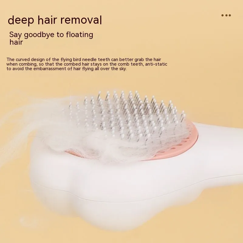 White plastic pet comb with one-click hair removal and massage feature for cat grooming