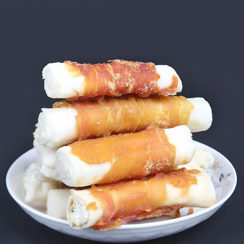 Dog teeth cleaning bones with chicken wrap around cowhide roll on white background
