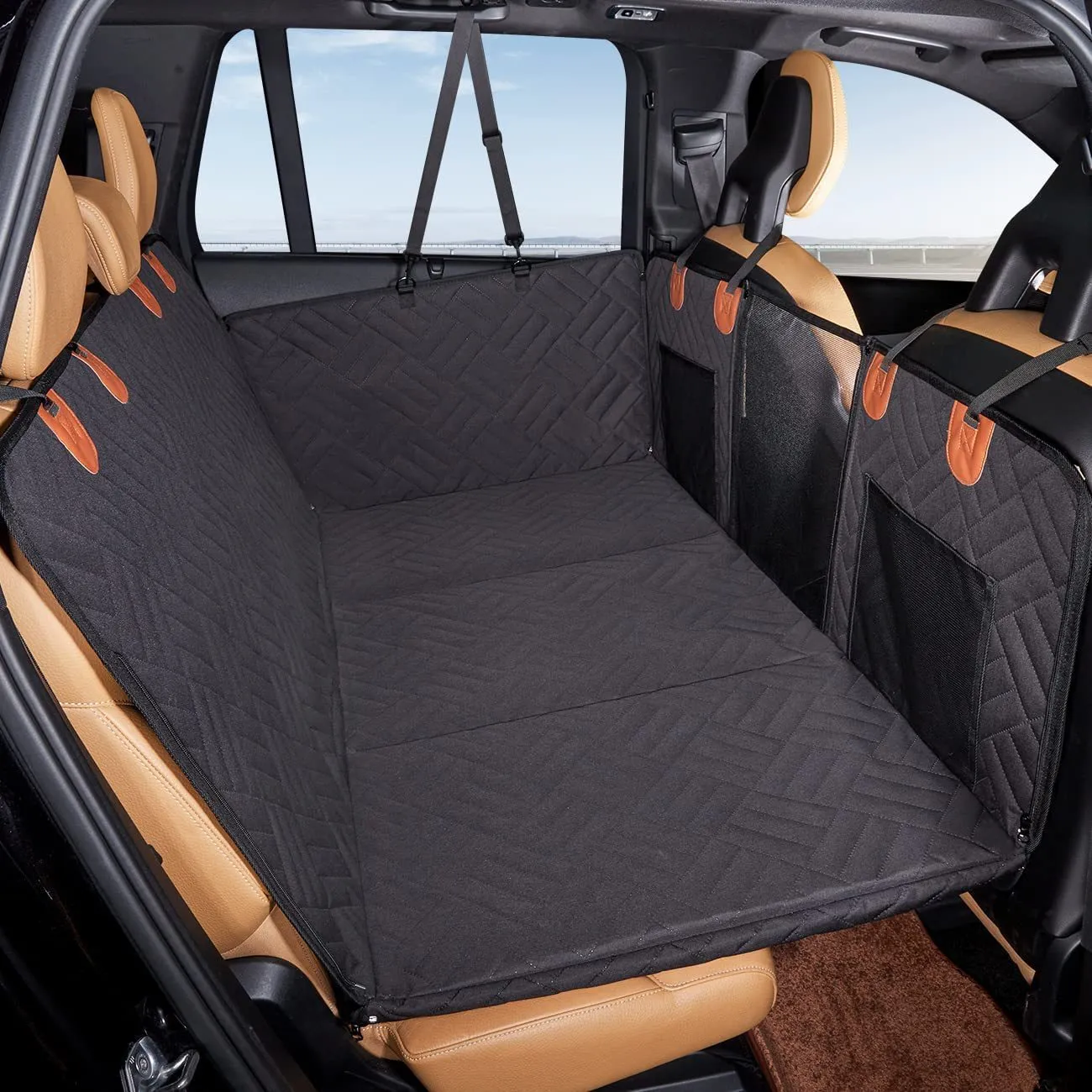 Black waterproof car dog bed cushion on rear seats protecting against pet mess