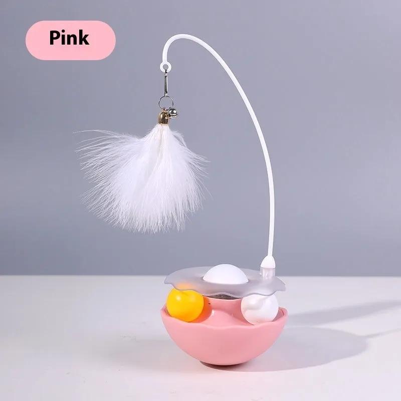 Cat interactive tumbler toy with feather wand and catnip ball on floor for kitten exercise