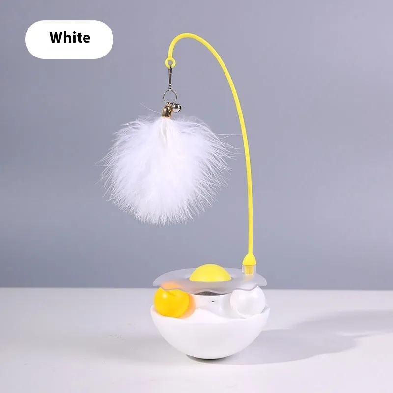 Cat interactive tumbler toy with feather wand and catnip ball on floor for kitten exercise