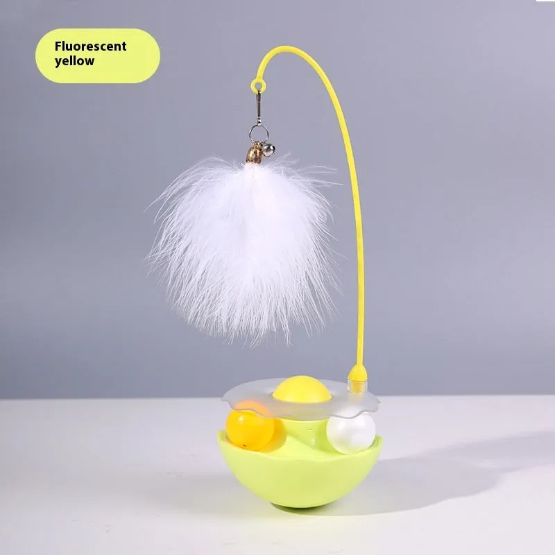 Cat interactive tumbler toy with feather wand and catnip ball on floor for kitten exercise