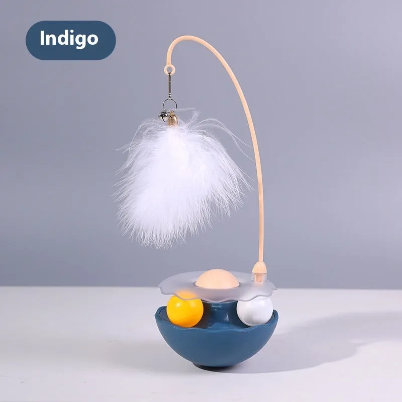 Cat interactive tumbler toy with feather wand and catnip ball on floor for kitten exercise
