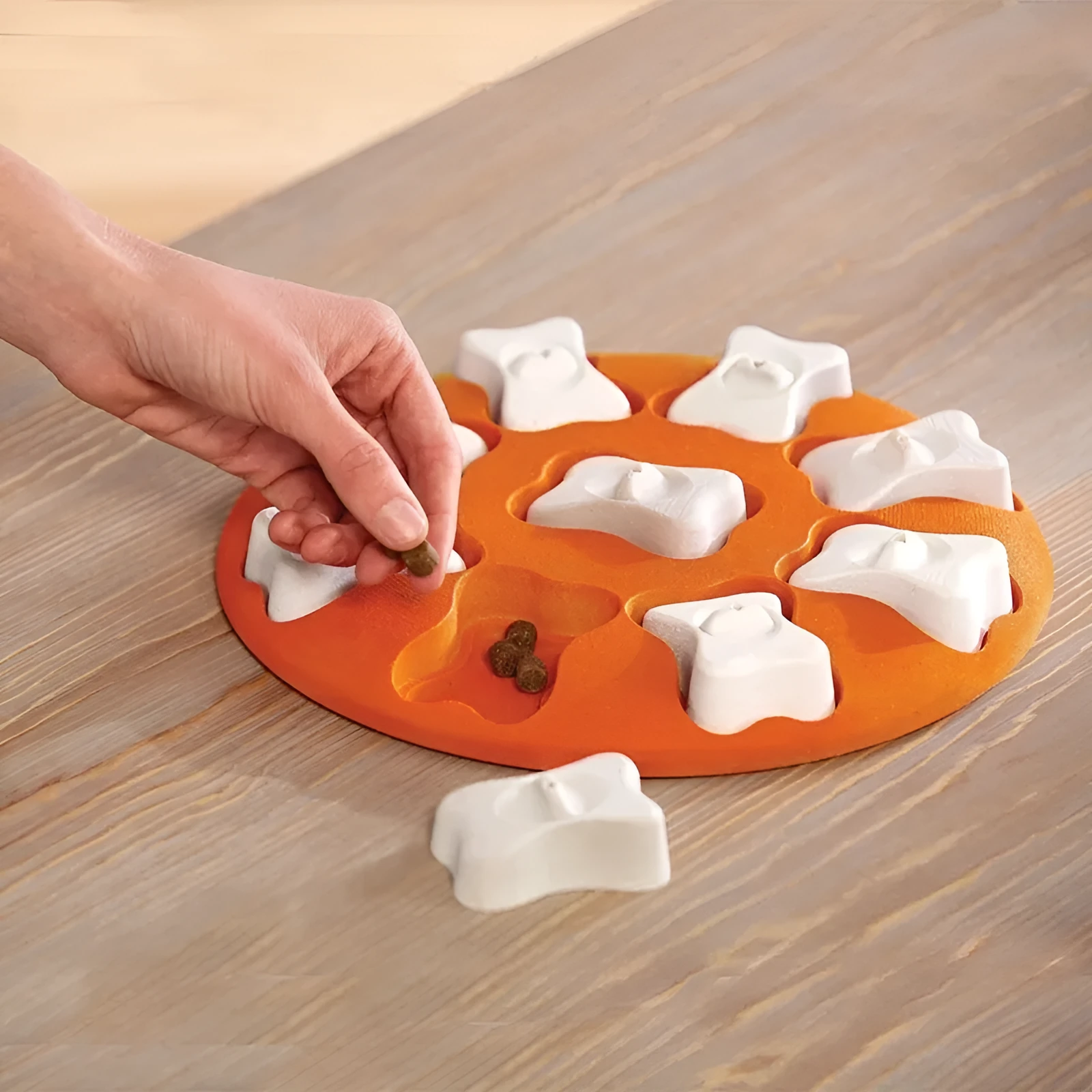 Orange and white plastic leak food toy for dogs and cats, puzzle feeder on surface