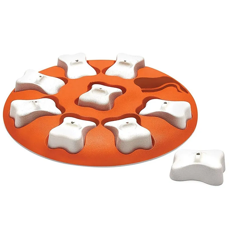 Orange and white plastic leak food toy for dogs and cats, puzzle feeder on surface