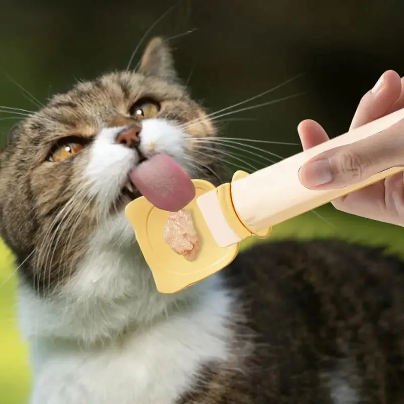 Cat Treat Spoon in green, orange, and white, measuring 27 x 6.5 cm, designed for scooping and serving cat strips