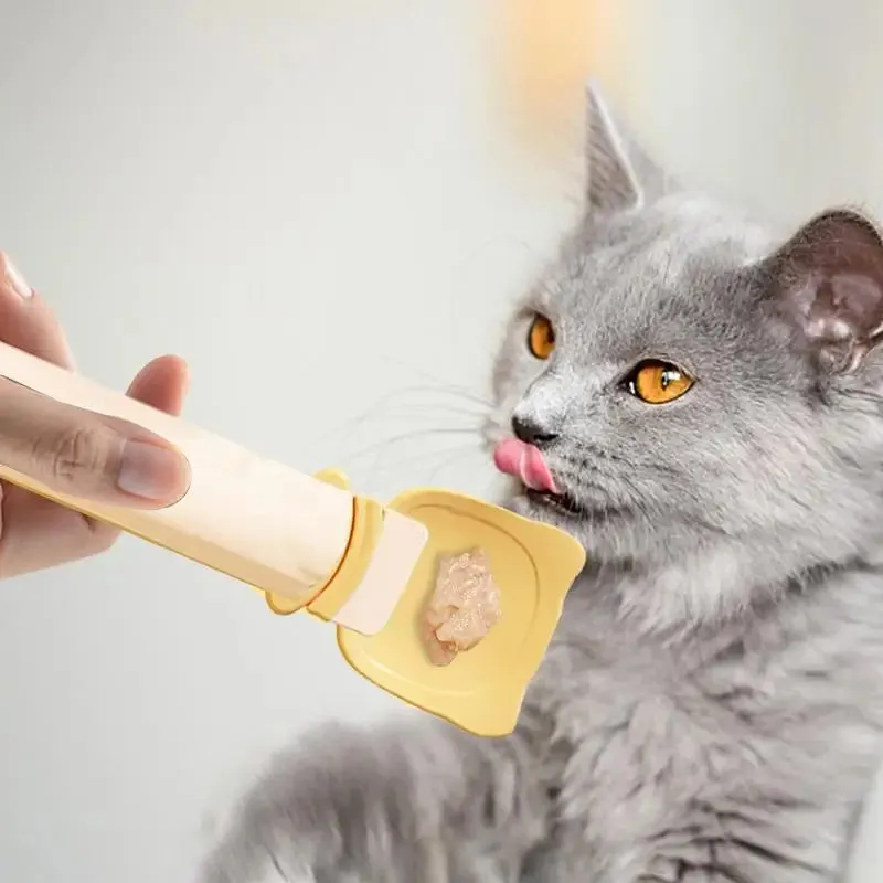 Cat Treat Spoon in green, orange, and white, measuring 27 x 6.5 cm, designed for scooping and serving cat strips